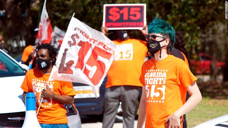 Protesters attend a rally for a $15 hourly minimum wage on February 16, 2021, in Orlando, Florida.