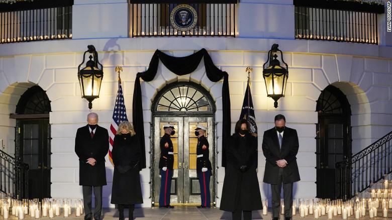 From left, President Joe Biden, First Lady Jill Biden, Vice President Kamala Harris and her husband Doug Emhoff, bow their heads during a ceremony to honor the 500,000 Americans that died from COVID-19, at the White House, Monday, Feb. 22, 2021, in Washington.