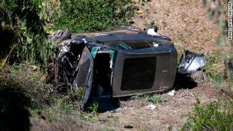 A vehicle rests on its side after a rollover accident involving golfer Tiger Woods along a road in the Rancho Palos Verdes section of Los Angeles on Tuesday.