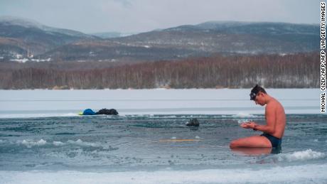 Czech freediver David Vencl rests on the icy Barbora lake near Teplice city, Czech Republic, on February 13, 2021 after his training to break the Guinness world record for the longest swim under ice.