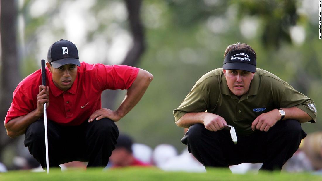 Woods and Phil Mickelson line up their putts during the final round of the Ford Championship in March 2005. For much of Woods&#39; career, Mickelson was considered his biggest rival.