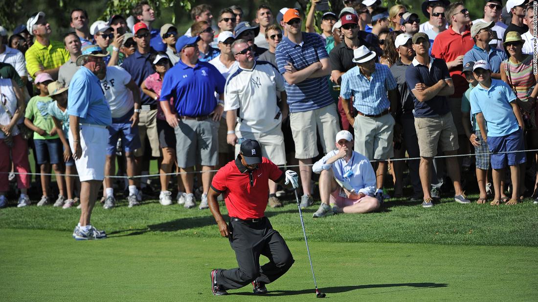 Woods falls to the ground in pain after hitting a shot at The Barclays in August 2013. A few months later, he would undergo back surgery for a pinched nerve.