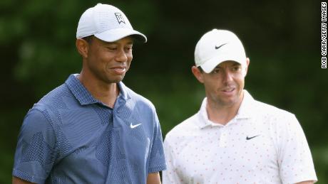 McIlroy (right) and Woods wait on the first tee in The Northern Trust's third round.
