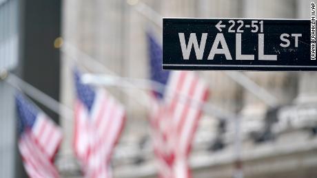 American flags hang oustside of the New York Stock Exchange Tuesday, Feb. 16, 2021, in New York. (AP Photo/Frank Franklin II)