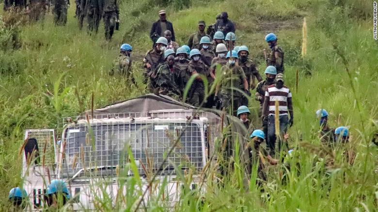 United Nations peacekeepers remove bodies from the area of the attack in North Kivu province on Monday