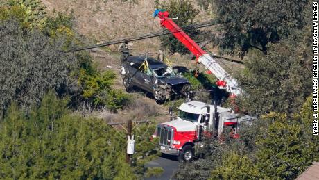 Workers move vehicle to a turnaround accident involving Tiger Woods on February 23, 2021