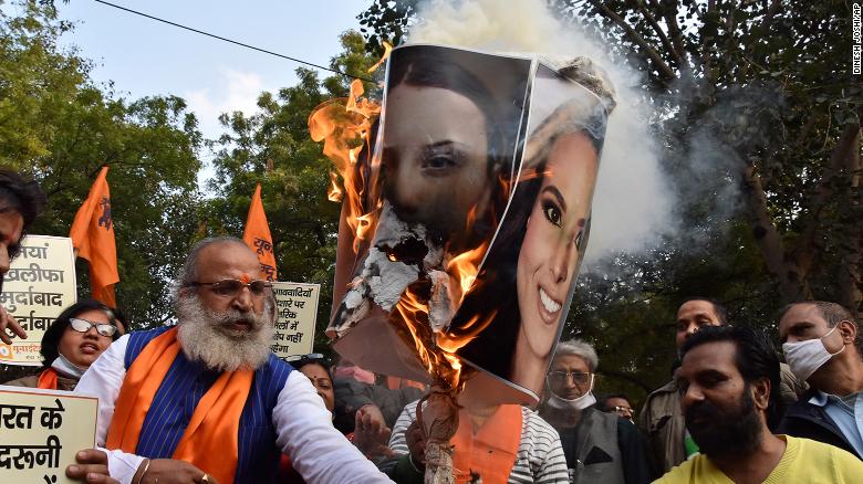 Crowds burn portraits of Meena Harris, niece of US Vice President Kamala Harris (right image), and Greta Thunberg in New Delhi, India, on  February 4.