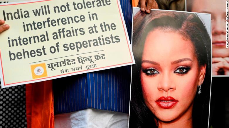 Members of the nationalist United Hindu Front hold an image of singer Rihanna during a demonstration in New Delhi on February 4.