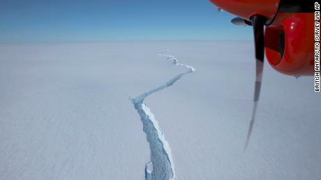 An airplane flies over the North Rift crack in the Brunt Ice Shelf in January.