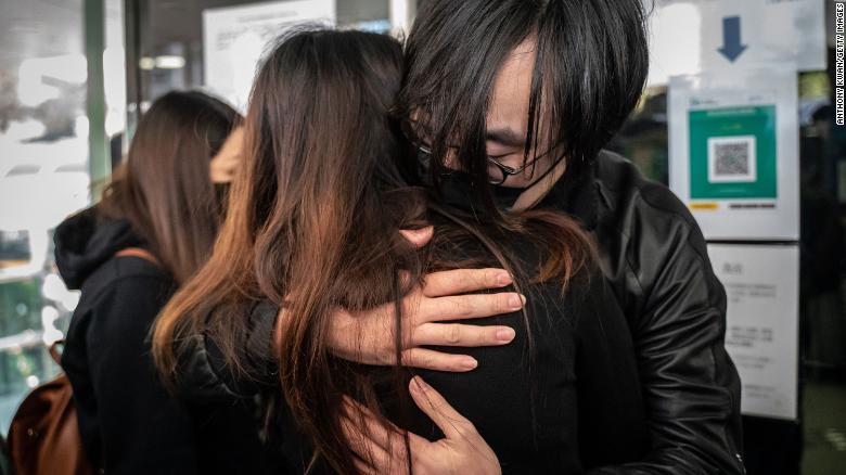 Mike Lam King-nam, who participated in the pro-democracy primary elections, gives a hug to his wife ahead of reporting the Ma On Shan Police Station on February 28, in Hong Kong.
