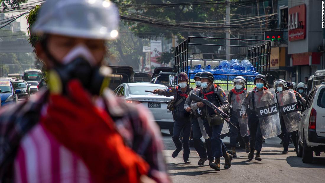 Police charge at anti-coup protesters in Yangon on February 27.