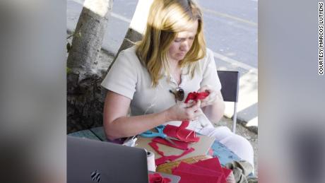 Volunteer Kait Walsh making roses at the Frogtown Artwalk in Los Angeles for Rose River Memorial.