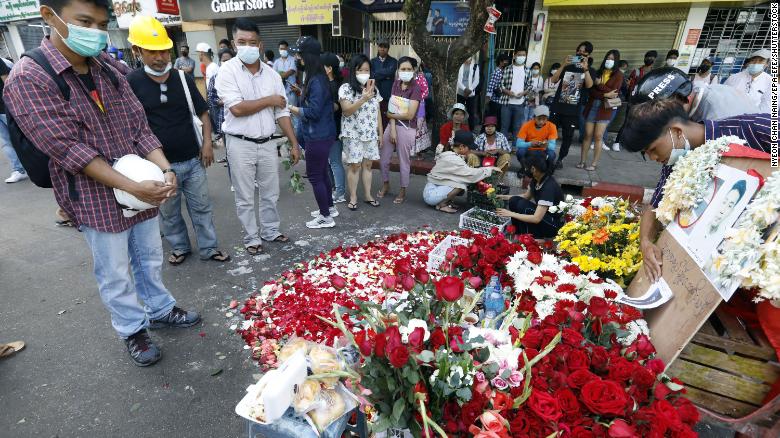 People attend a prayer for a young protester who was killed during a crackdown on anti-coup protesters, near Hledan junction in Yangon on March 1. 