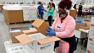 SHEPHERDSVILLE, KENTUCKY - MARCH 01:  An employee with the McKesson Corporation packs a box of the Johnson and Johnson COVID vaccine into a cooler for shipping from their facility on March 1, 2021 in Shepherdsville, Kentucky. The FDA has approved a third vaccine and 3.9 million doses of J&amp;J will begin distribution.  (Photo by Timothy D. Easley-Pool/Getty Images)