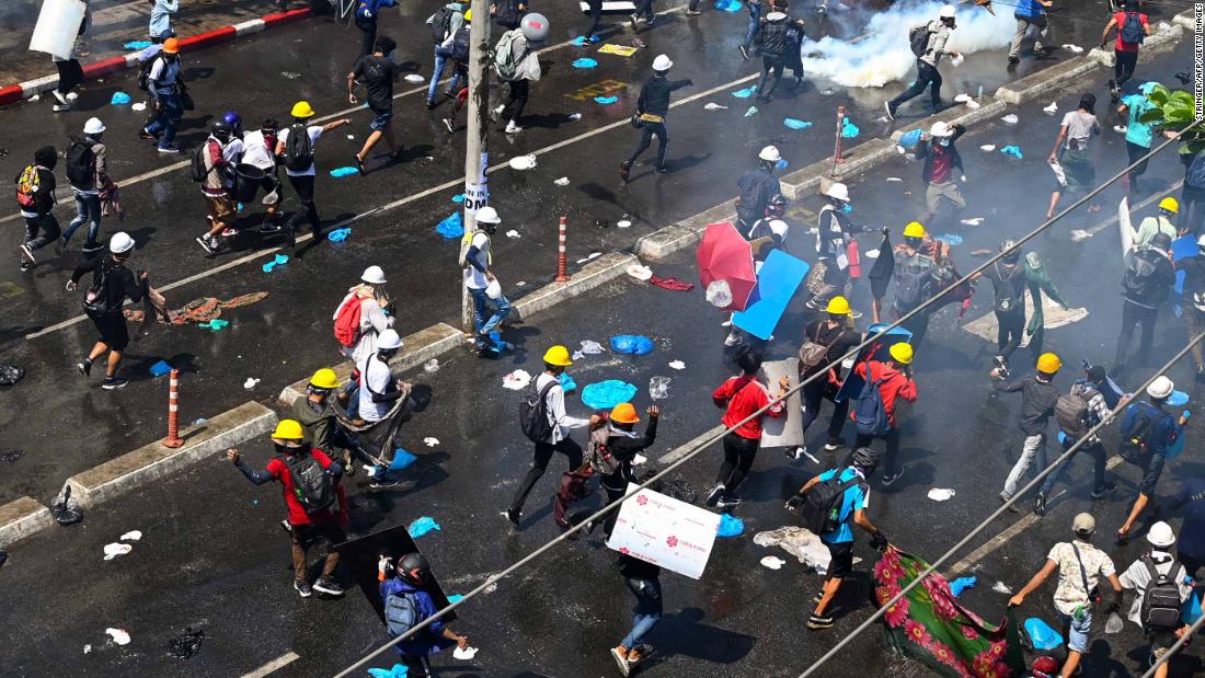 Protesters flee after tear gas was fired during a demonstration in Yangon on March 1.