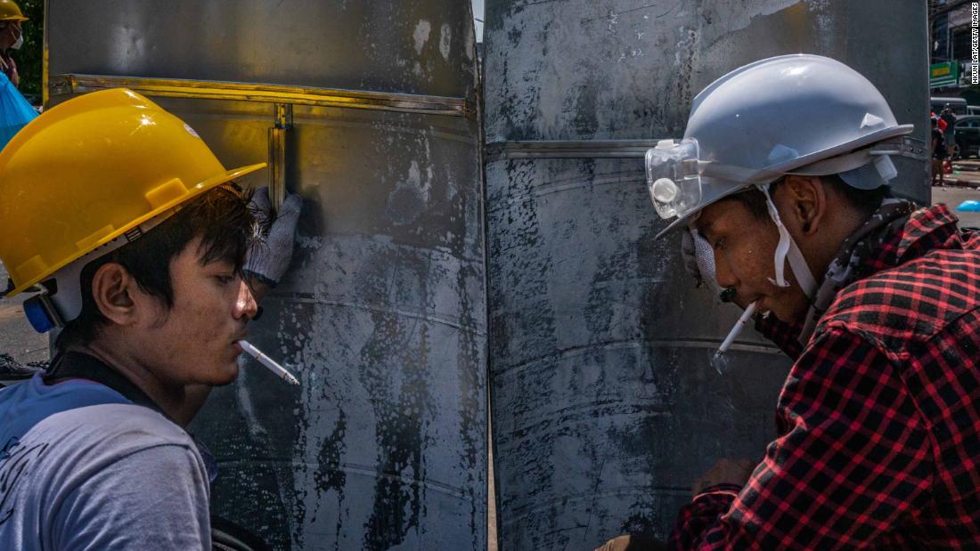 Protesters smoke behind shields during a demonstration in Yangon on March 1.