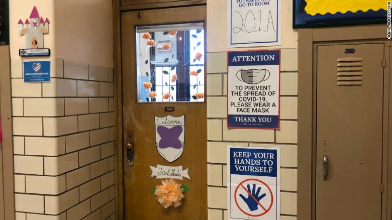 New signs encouraging practices to prevent the spread of Covid-19 are posted next to a &quot;Welcome&quot; decoration for first-graders at Hawthorne Scholastic Academy in Chicago.