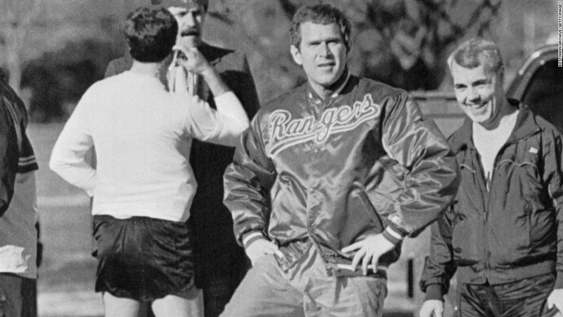 Bush has a &quot;leg up&quot; on his father as he clowns around for the camera in 1990. A year earlier, the younger Bush became part-owner of the Texas Rangers baseball team.