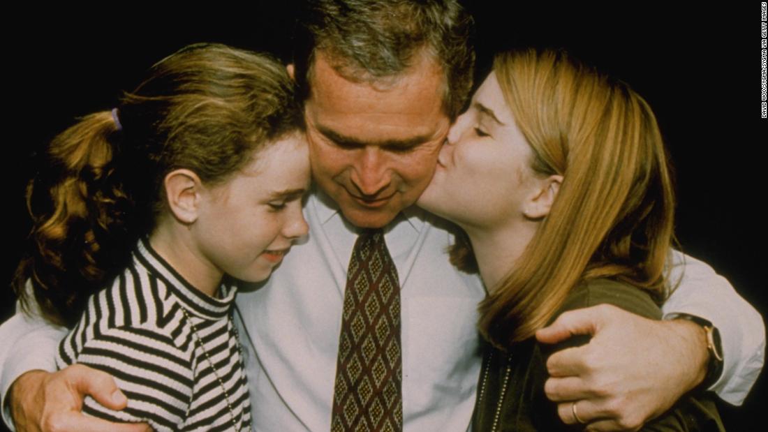 Bush hugs his daughters Barbara, left, and Jenna after his election win in 1994.