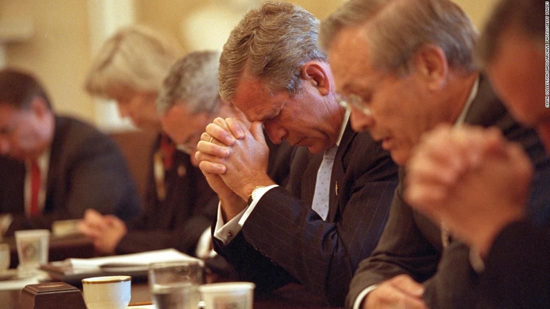 Bush and his Cabinet bow their heads in prayer before a White House meeting on September 14, 2001.