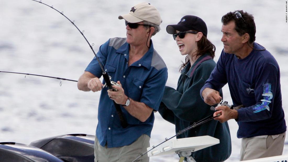 Bush reels in a catch in Kennebunkport, Maine, in 2007. Watching is his daughter, Barbara, and cousin Billy.