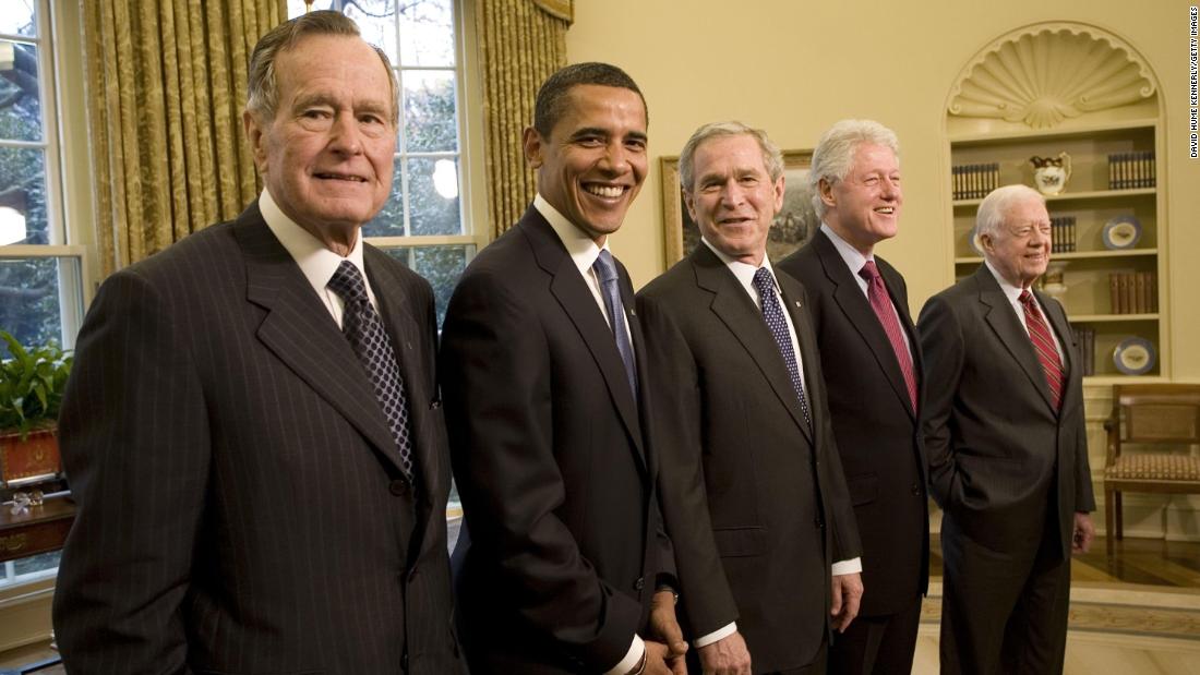 Bush poses with President-elect Barack Obama and three former presidents in the White House Oval Office in January 2009.