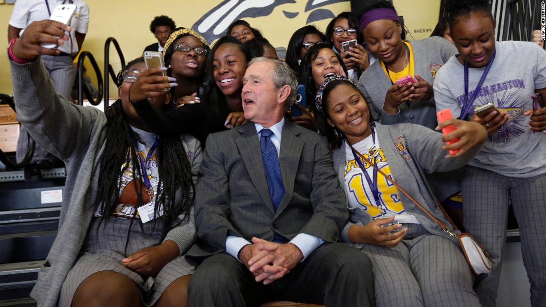 Bush poses with students at a New Orleans high school in 2015. He was in town for the 10th anniversary of Hurricane Katrina.