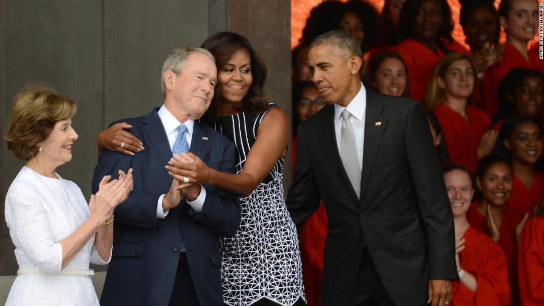 First lady Michelle Obama embraces Bush at the dedication of the National Museum of African American History and Culture in 2016.