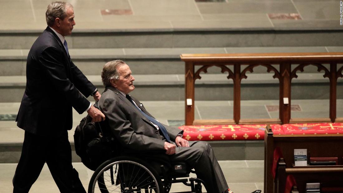 Bush pushes his father&#39;s wheelchair at the funeral service for his mother, Barbara, in April 2018.