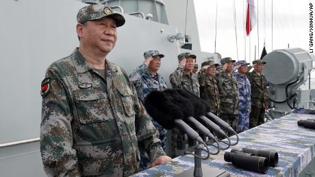 In this April 12, 2018, file photo released by Xinhua News Agency, Chinese President Xi Jinping, left, speaks after he reviewed the Chinese People&#39;s Liberation Army (PLA) Navy fleet in the South China Sea. From Asia to Africa, London to Berlin, Chinese envoys have set off diplomatic firestorms with a combative defense whenever their country is accused of not acting quickly enough to stem the spread of the coronavirus pandemic.