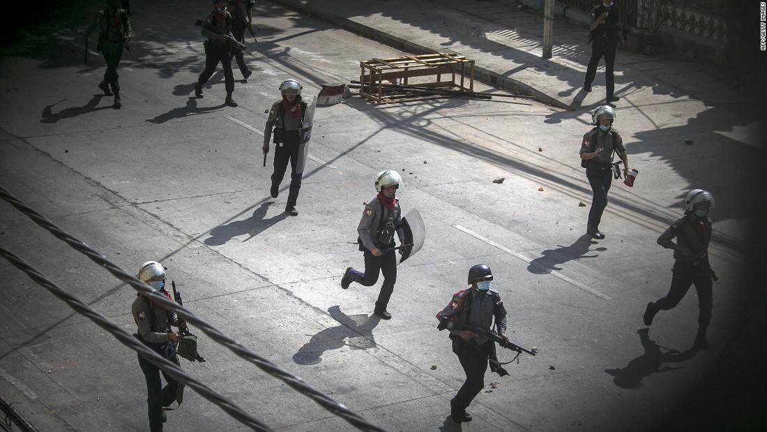 Police run toward protesters to disperse a demonstration in Yangon on March 3.