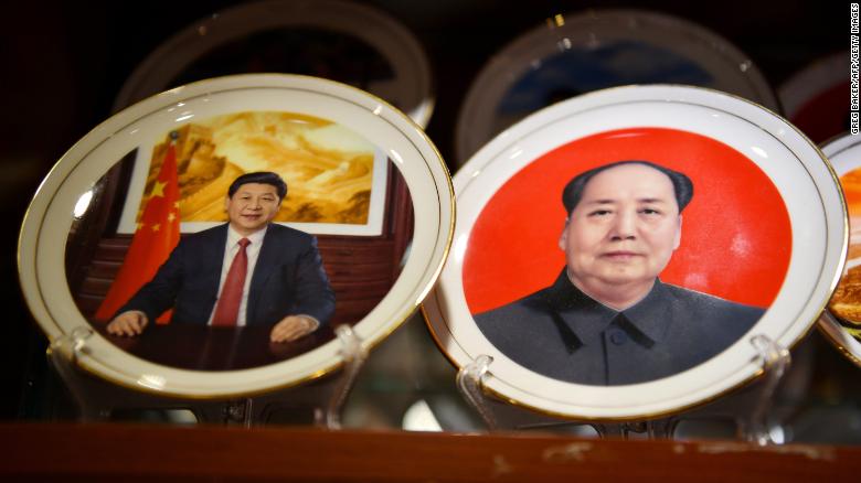 Souvenir plates featuring Chinese President Xi Jinping (L) and late communist leader Mao Zedong are seen at a store in Beijing on March 2,