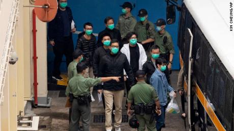 Certains des 47 militants pro-démocratie, dont Lam Chuck Ting, dans le centre, escortent des agents pénitentiaires jusqu'à un camion de la prison jeudi.
