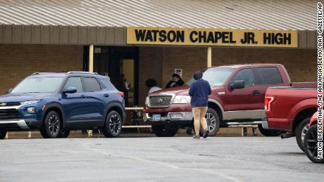 Parents pick up students from the school on Monday after the shooting.