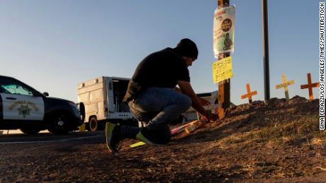 Hugo Castro, an activist with the Coalition for Humane Immigrant Rights, leaves cross at California crash site. 