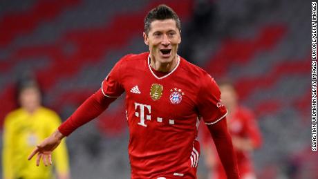 MUNICH, GERMANY - MARCH 06: Robert Lewandowski of FC Bayern Muenchen celebrates after scoring their side&#39;s fourth goal, completing his hat-trick during the Bundesliga match between FC Bayern Muenchen and Borussia Dortmund at Allianz Arena on March 06, 2021 in Munich, Germany. Sporting stadiums around Germany remain under strict restrictions due to the Coronavirus Pandemic as Government social distancing laws prohibit fans inside venues resulting in games being played behind closed doors. (Photo by Sebastian Widmann/Getty Images)