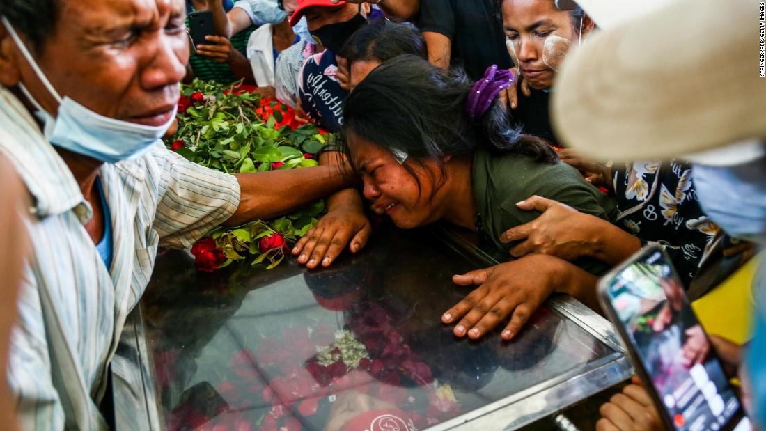 The wife of Phoe Chit, a protester who died during a demonstration, cries over her husband&#39;s coffin during his funeral in Yangon on March 5.