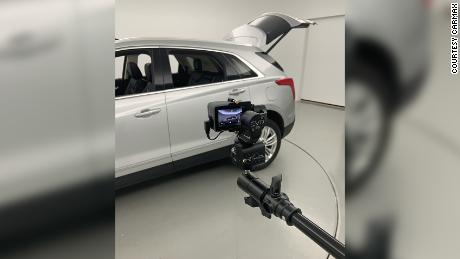 An SUV about to be listed for sale on CarMax&#39;s website is photographed using a camera that will create a fully rotatable 360-degree image. 