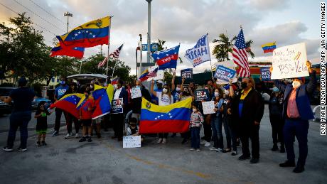 Venezuelans gather to celebrate the granting of a temporary protected status (TPS) by US President Joe Biden in front of El Arepazo restaurant in Miami on March 9, 2021. 