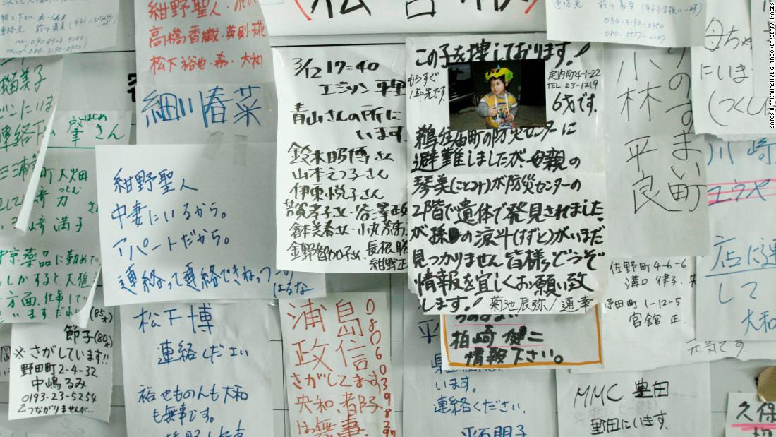 A bulletin board lists the names of people missing in the disaster, as families tried to find their loved ones. 