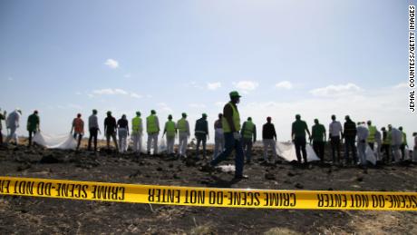 Forensics investigators and recovery teams collect personal effects and other materials from the crash site of Ethiopian Airlines Flight ET 302 on March 12, 2019 in Bishoftu, Ethiopia. 