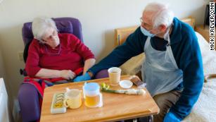 They can only hold hands, but for Britain's elderly, first touch with a relative 'means everything'