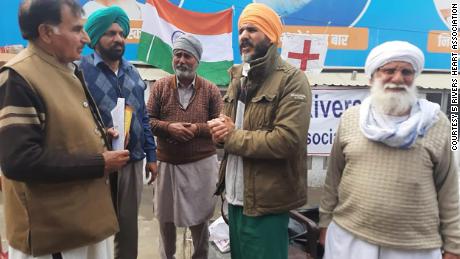 Dr. Swaiman Singh, second from right, stands with others at a protest site in New Delhi, India.