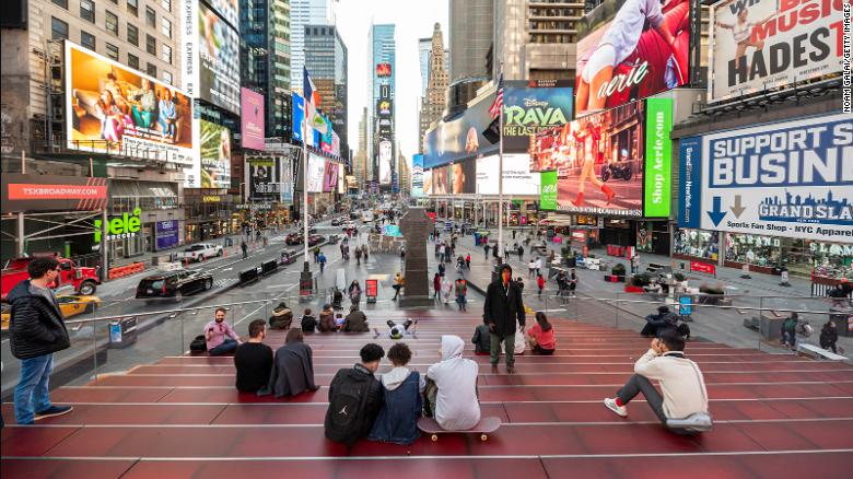 People visit the Red Steps in Times Square amid the coronavirus pandemic on March 9, 2021 in New York City