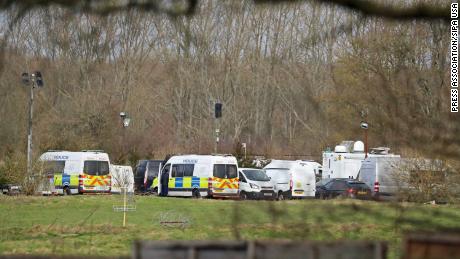 Police vehicles parked Thursday near Ashford in Kent following the discovery of human remains in the hunt for missing Sarah Everard.
