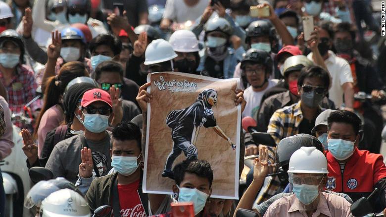 People display a poster of Angel during her funeral on March 4.