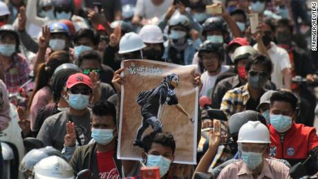 People display a poster of Angel during her funeral on March 4.