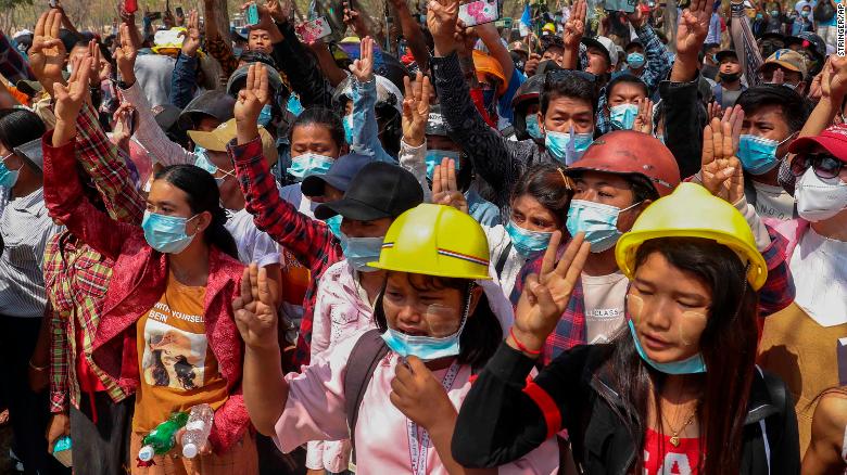 People flash a three-finger sign of resistance during Angel&#39;s funeral on March 4.