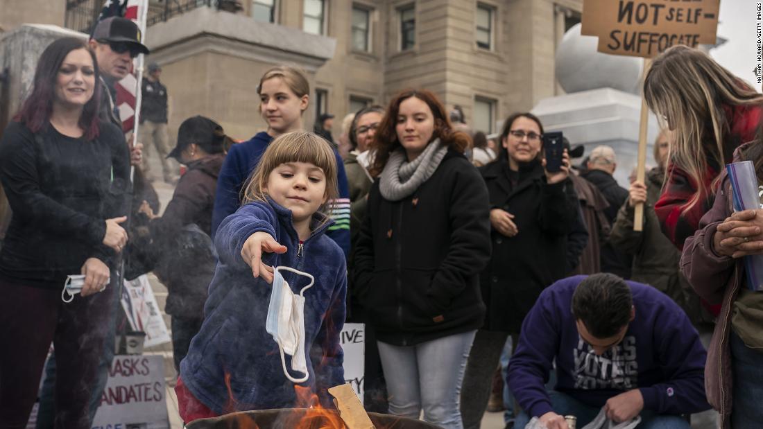 A child tosses a surgical mask into a fire during a mask-burning event at the Idaho Statehouse in Boise on March 6. People gathered in at least 20 cities across the state &lt;a href=&quot;https://www.cnn.com/videos/politics/2021/03/09/burn-the-mask-rallies-idaho-lauren-mclean-sot-ebof-vpx.cnn&quot; target=&quot;_blank&quot;&gt;to protest Covid-19 restrictions. &lt;/a&gt;