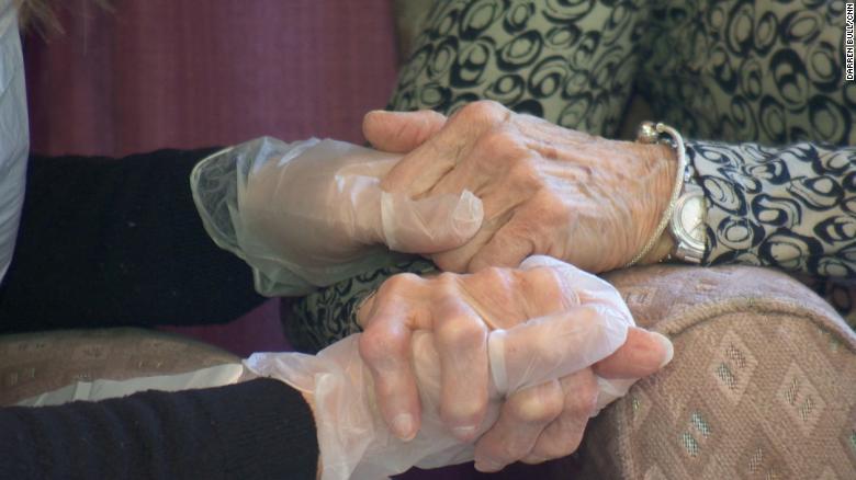 Some of Britain's elderly hold hands for first time in months 